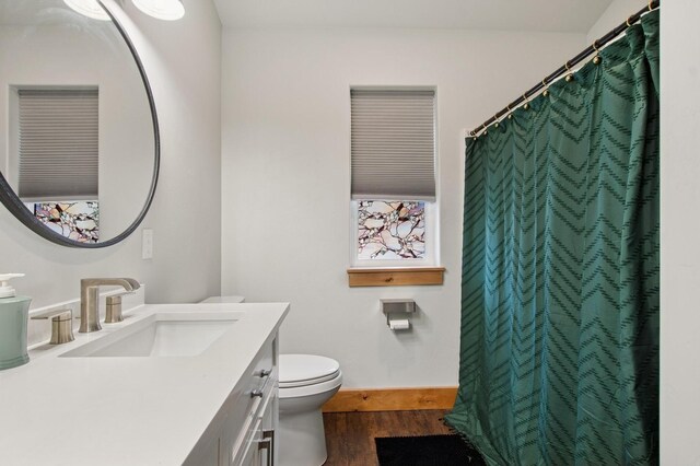 empty room with baseboards, lofted ceiling, and dark wood-style floors