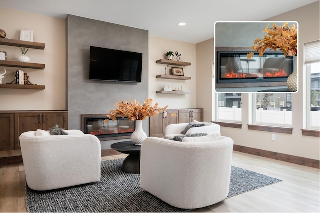 kitchen with decorative backsplash, light wood-style floors, high quality appliances, and white cabinetry