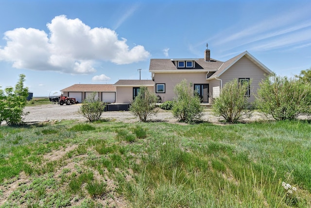 8745 US Highway 91 N, Conrad, MT 59425 - back of house with a chimney and a garage
