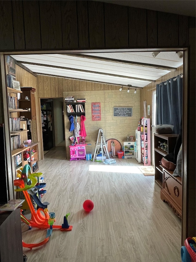 game room featuring wood finished floors and wooden walls
