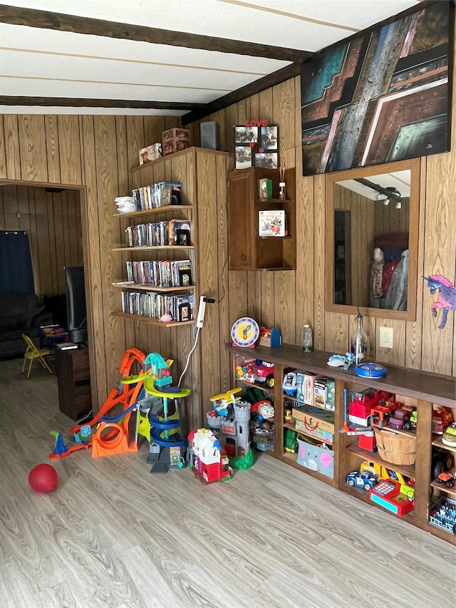 playroom featuring wood finished floors and wooden walls