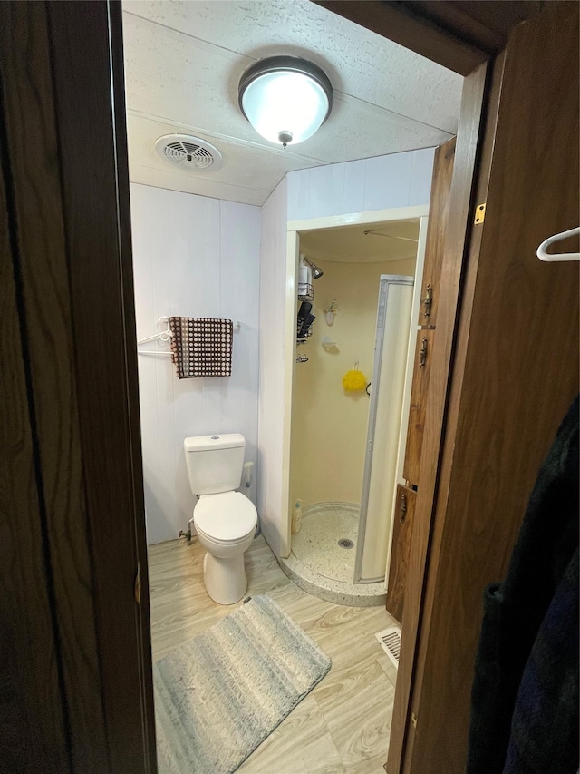 381 Lyng Ave W, Highwood, MT 59450 - bathroom with a stall shower, wood finished floors, and toilet