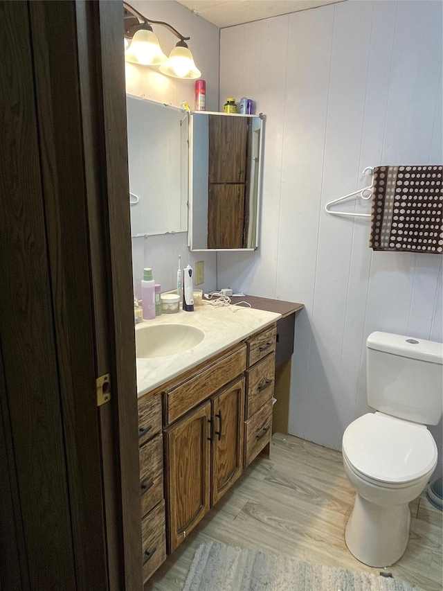 381 Lyng Ave W, Highwood, MT 59450 - half bathroom featuring vanity, wood finished floors, and toilet