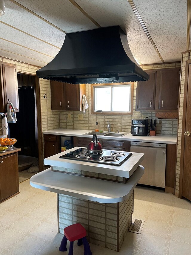 381 Lyng Ave W, Highwood, MT 59450 - kitchen with black appliances, light floors, custom range hood, and light countertops