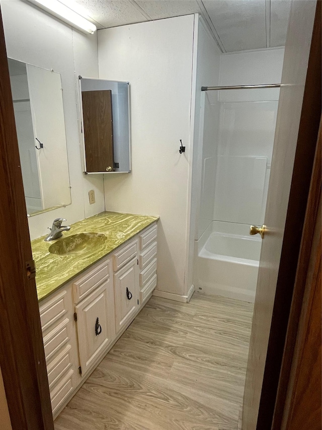 381 Lyng Ave W, Highwood, MT 59450 - full bathroom featuring vanity, wood finished floors, baseboards, and bathtub / shower combination