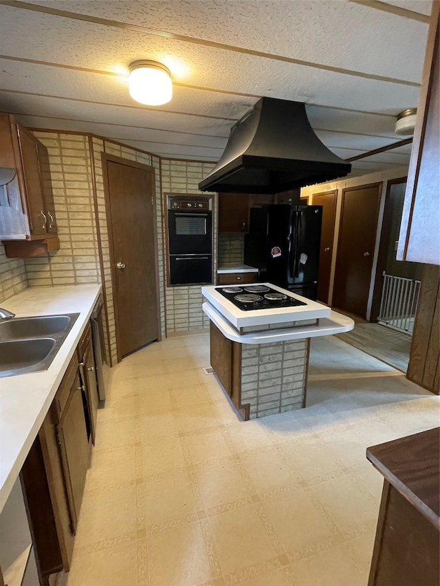 381 Lyng Ave W, Highwood, MT 59450 - kitchen with island range hood, black appliances, a sink, a center island, and light countertops