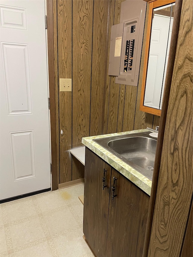 381 Lyng Ave W, Highwood, MT 59450 - bathroom with electric panel, wooden walls, vanity, and tile patterned floors