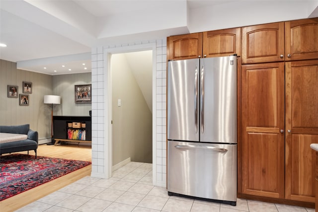 kitchen featuring freestanding refrigerator, brown cabinets, baseboard heating, baseboards, and recessed lighting