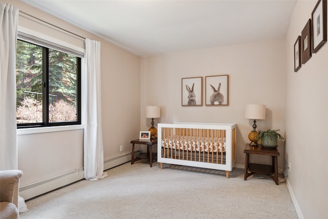 bedroom featuring carpet, a baseboard heating unit, and baseboards