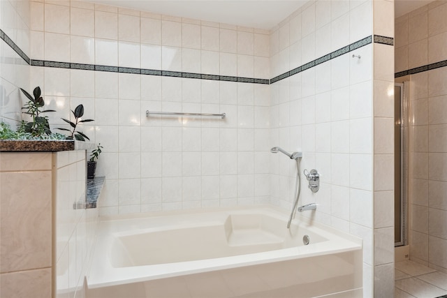 bathroom with tile walls, a garden tub, and an enclosed shower