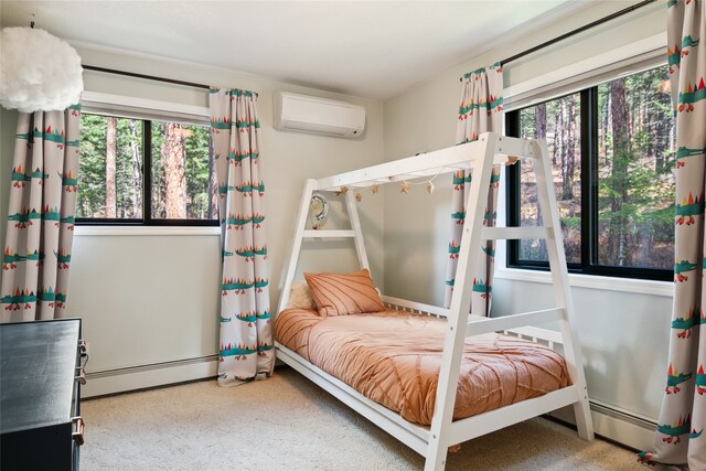 bedroom with a wall mounted AC and a baseboard radiator