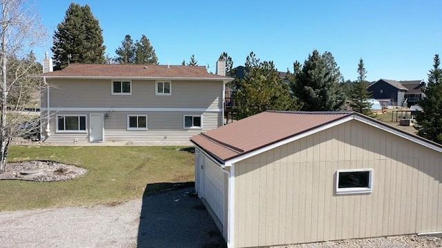 rear view of property with a yard