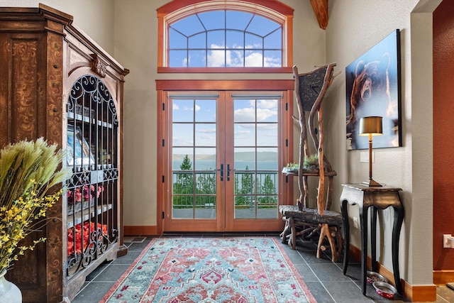 31572 Lake To Sky Dr, Bigfork, MT 59911 - tiled entrance foyer featuring french doors, healthy amount of natural light, and a towering ceiling