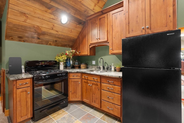 31572 Lake To Sky Dr, Bigfork, MT 59911 - kitchen with black appliances, lofted ceiling, light stone countertops, brown cabinetry, and wooden ceiling