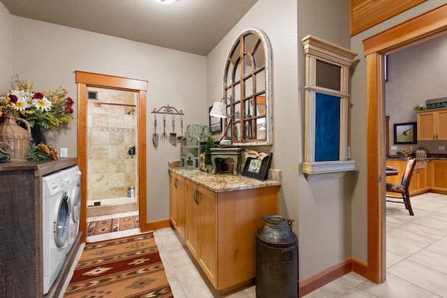 31572 Lake To Sky Dr, Bigfork, MT 59911 - laundry room with light tile patterned floors and washer and clothes dryer