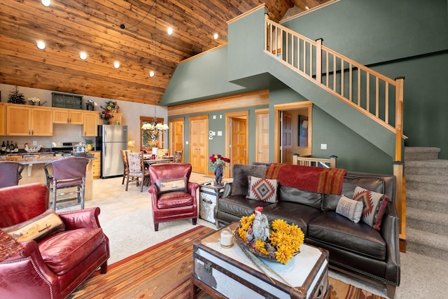 31572 Lake To Sky Dr, Bigfork, MT 59911 - living room featuring wood ceiling, high vaulted ceiling, stairs, a chandelier, and light tile patterned flooring