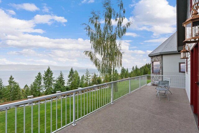 31572 Lake To Sky Dr, Bigfork, MT 59911 - patio / terrace featuring a water view and a yard