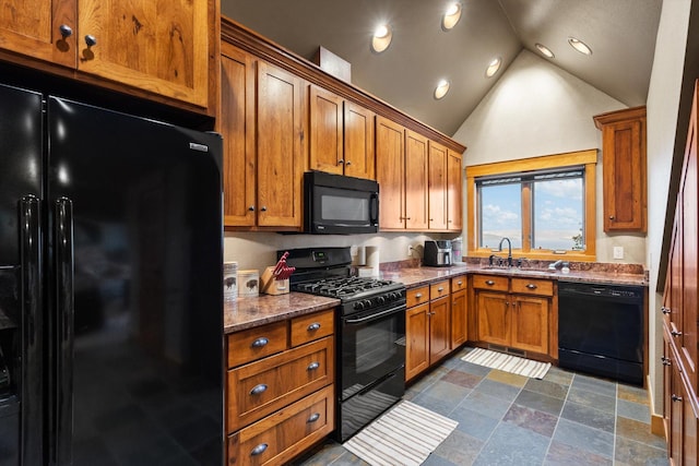 31572 Lake To Sky Dr, Bigfork, MT 59911 - kitchen with black appliances, brown cabinets, lofted ceiling, dark stone countertops, and recessed lighting