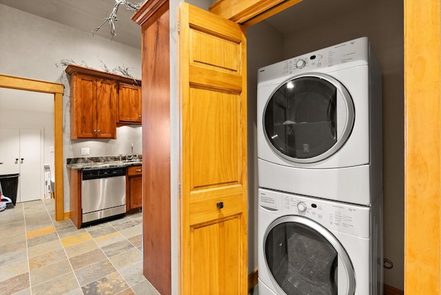 31572 Lake To Sky Dr, Bigfork, MT 59911 - laundry room with stacked washer / drying machine and light stone finish floors