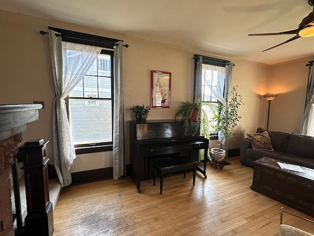 815 3rd Ave E, Kalispell, MT 59901 - living room featuring a ceiling fan, light wood-type flooring, a fireplace, and crown molding