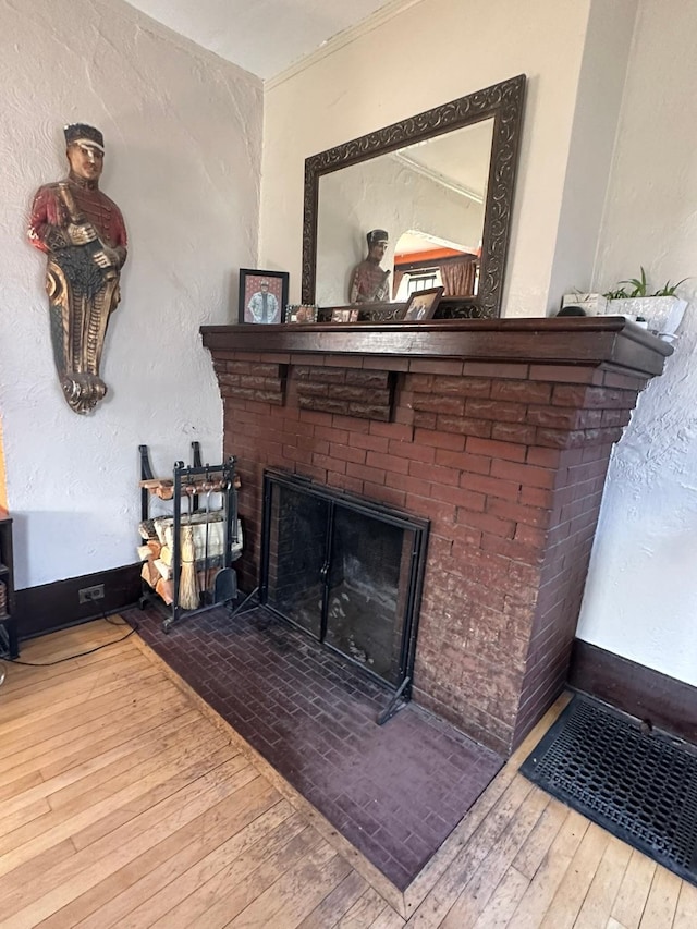 815 3rd Ave E, Kalispell, MT 59901 - detailed view of wood finished floors, a fireplace, and a textured wall