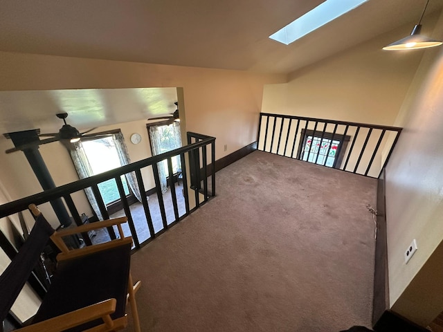 815 3rd Ave E, Kalispell, MT 59901 - stairs featuring carpet flooring, ceiling fan, a skylight, baseboards, and lofted ceiling
