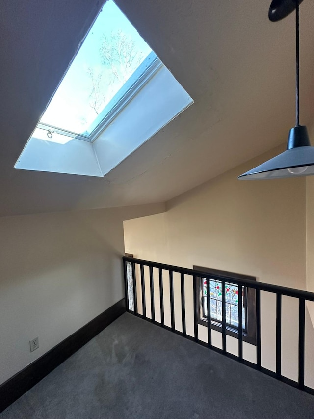 815 3rd Ave E, Kalispell, MT 59901 - additional living space featuring a skylight, carpet, baseboards, and vaulted ceiling