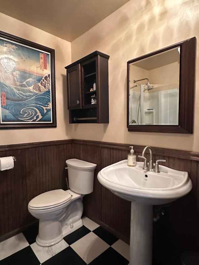 815 3rd Ave E, Kalispell, MT 59901 - bathroom with a wainscoted wall, tile patterned floors, toilet, and a sink
