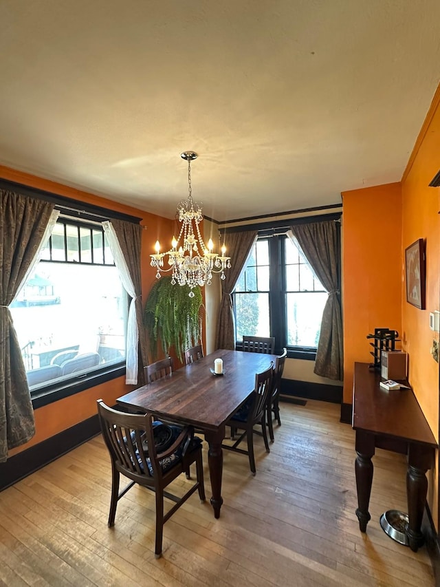 815 3rd Ave E, Kalispell, MT 59901 - dining space with hardwood / wood-style floors, a chandelier, and baseboards