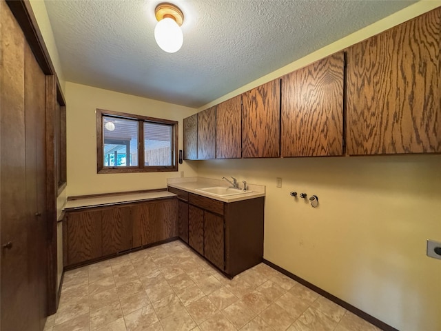 306 Parker Lakes Rd, Bigfork, MT 59911 - washroom featuring electric dryer hookup, cabinet space, a textured ceiling, and washer hookup
