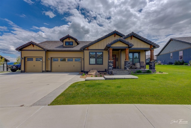 2883 Alpine View Loop, Helena, MT 59601 - craftsman-style home with a garage, covered porch, a front lawn, driveway, and board and batten siding