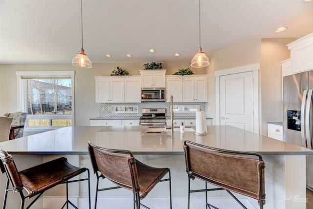 2883 Alpine View Loop, Helena, MT 59601 - kitchen featuring stainless steel appliances, decorative backsplash, a spacious island, white cabinets, and recessed lighting