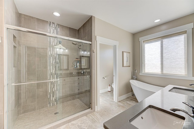2883 Alpine View Loop, Helena, MT 59601 - bathroom featuring a stall shower, toilet, recessed lighting, baseboards, and double vanity