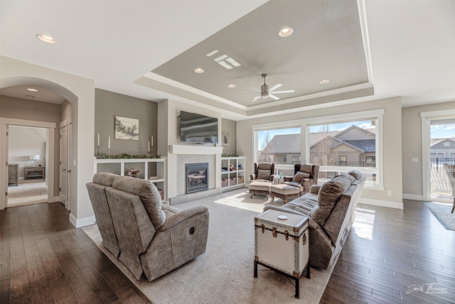 2883 Alpine View Loop, Helena, MT 59601 - living room with a tray ceiling, arched walkways, a ceiling fan, dark wood-style floors, and recessed lighting