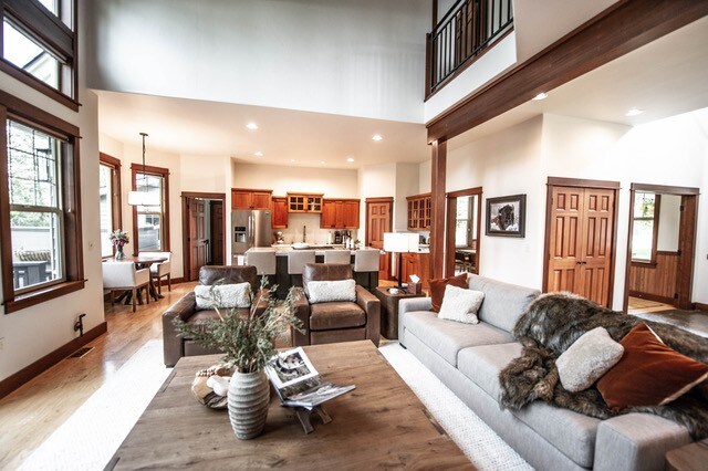 255 Windsor Ct, Bigfork, MT 59911 - living room featuring a towering ceiling, light wood-type flooring, recessed lighting, and baseboards