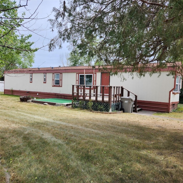 4612 Richlie St, Missoula, MT 59808 - rear view of house featuring a wooden deck and a lawn