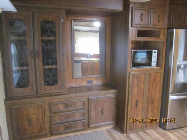 4612 Richlie St, Missoula, MT 59808 - kitchen with stainless steel fridge with ice dispenser, white microwave, and brown cabinets