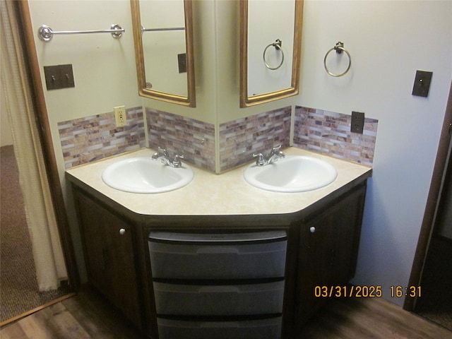 4612 Richlie St, Missoula, MT 59808 - full bathroom with double vanity, decorative backsplash, and wood finished floors