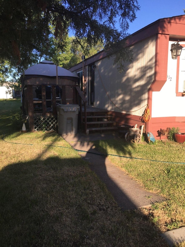 rear view of property featuring a yard and a deck