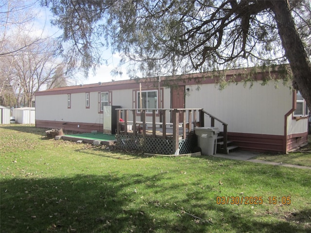 4612 Richlie St, Missoula, MT 59808 - rear view of house with a wooden deck, a lawn, crawl space, and a shed