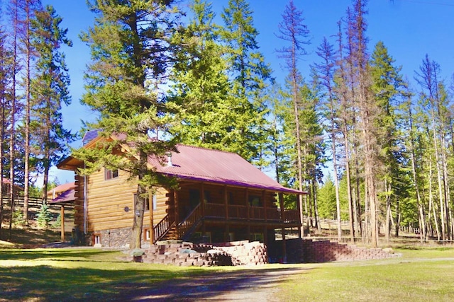 view of home's exterior with a yard and log exterior