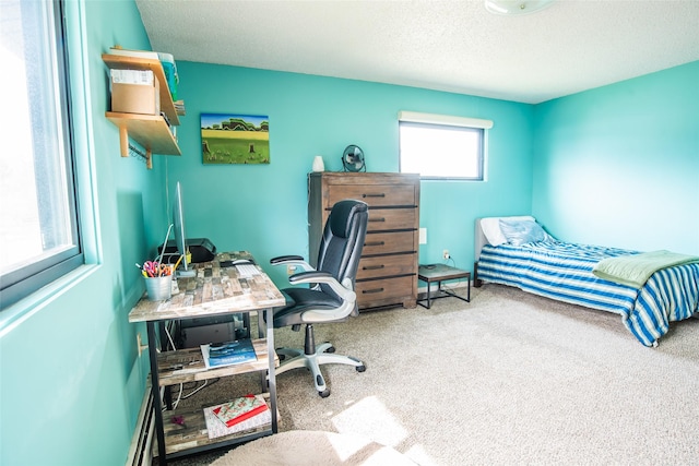 carpeted office space featuring a textured ceiling