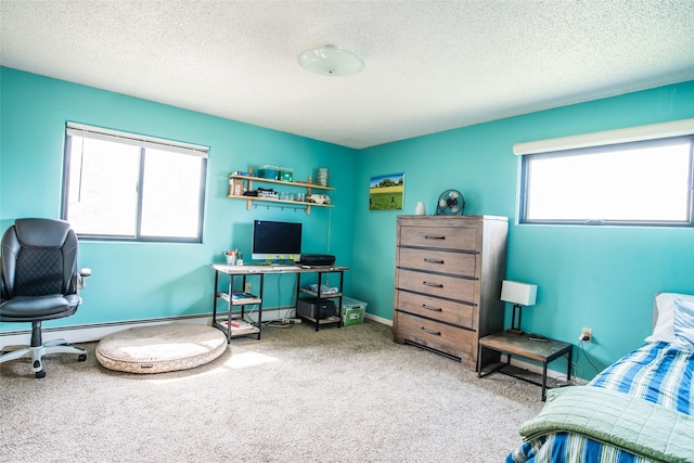 bedroom featuring a textured ceiling, carpet, and baseboards