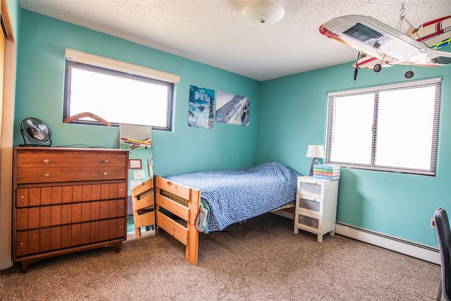 bedroom with a textured ceiling, carpet floors, and a baseboard radiator