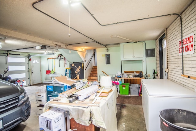 garage featuring white refrigerator, a garage door opener, and electric panel