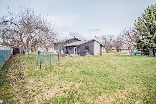view of yard with fence and central AC unit