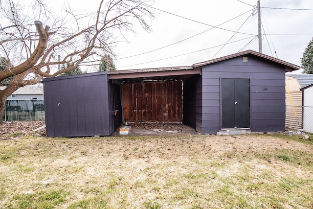 view of shed featuring fence