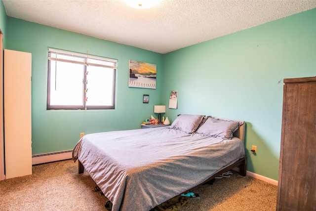 carpeted bedroom featuring a textured ceiling, a baseboard heating unit, and baseboards