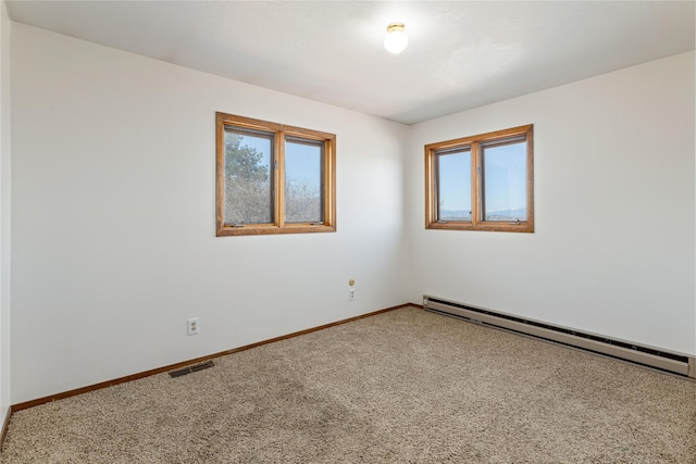 carpeted spare room featuring a baseboard radiator, baseboards, visible vents, and plenty of natural light