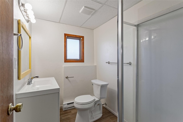 full bath featuring visible vents, toilet, a baseboard radiator, wood finish floors, and a drop ceiling
